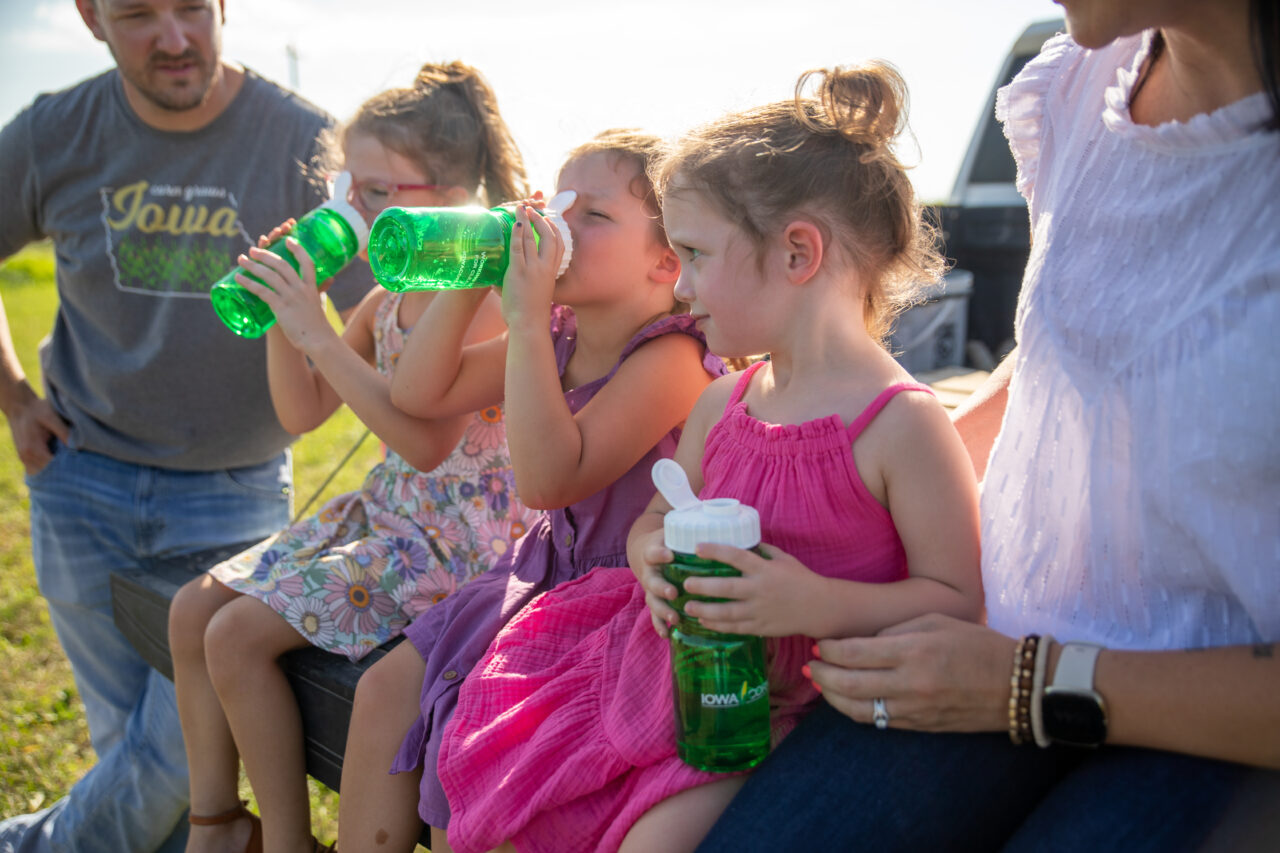 Kids drinking water at Iowa Corn event