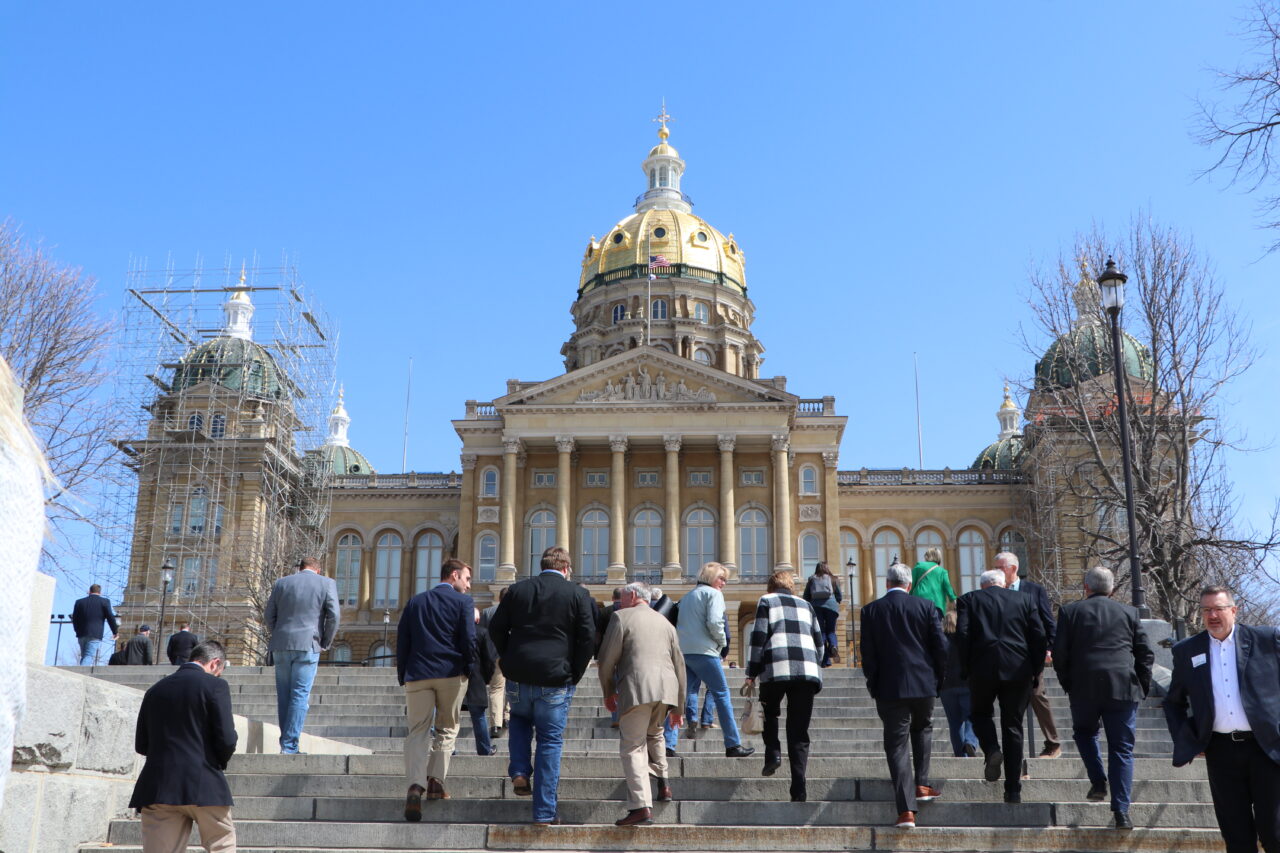 People walking up the steps to a capitol building