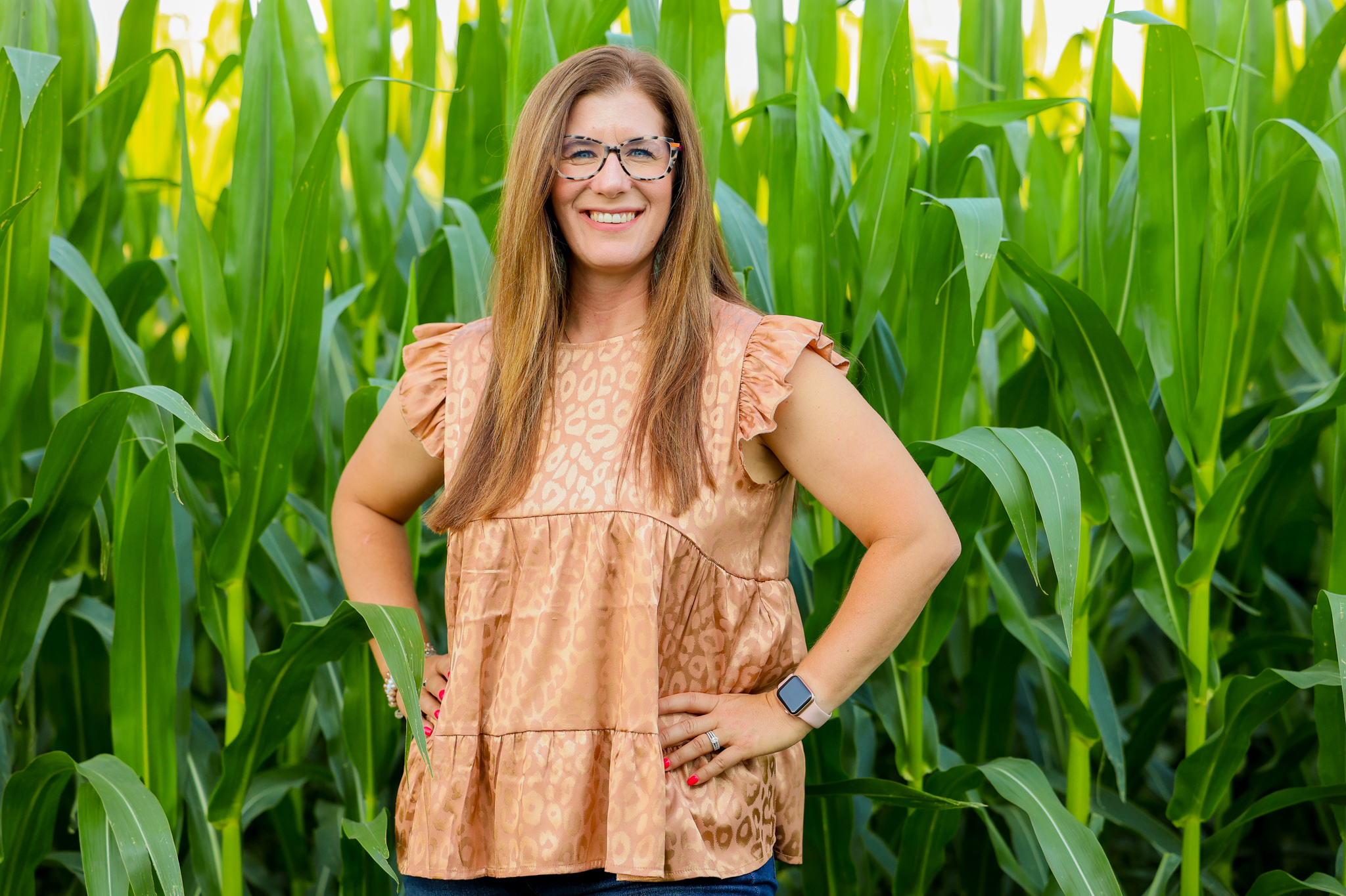 Shea Greiner in front of a field of corn